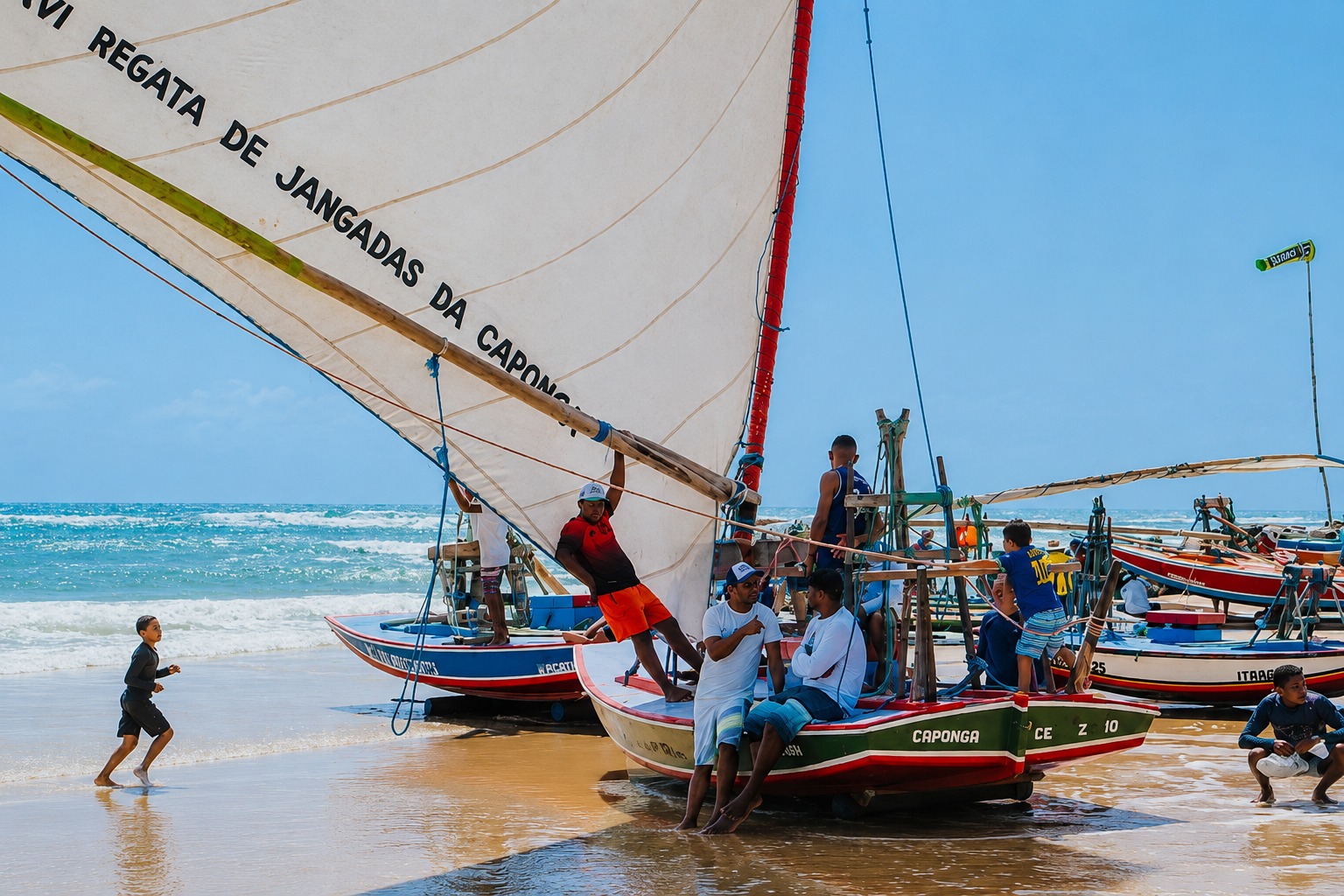 Jangadas coloridas na Praia da Caponga durante a regata, com mar azul ao fundo.